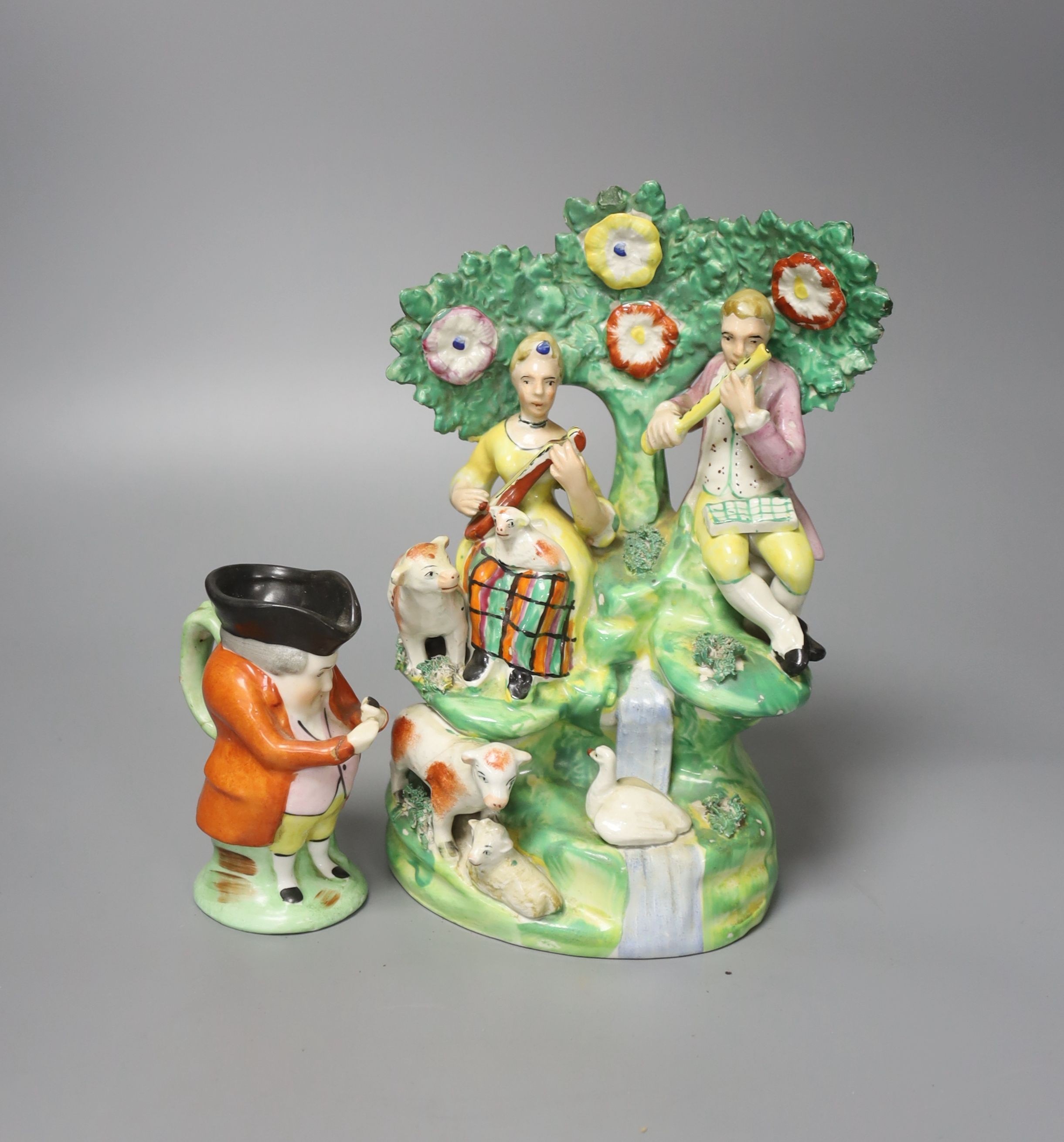 A Staffordshire figure group and character jug 21cm